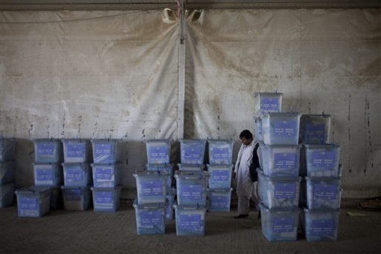 An Afghan election worker checks ballot boxes at Afghanistan's Independent Election Commission in Kabul on Sunday. Afghan election observers said they had serious concerns about the legitimacy of Saturday's parliamentary balloting as officials began Sunday to tally the results, a process that could take months. 
